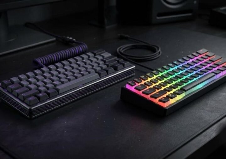 IQUNIX EV63 aluminum and forged carbon keyboard next to a Wooting 60HE Plus with RGB lighting on a dark desk