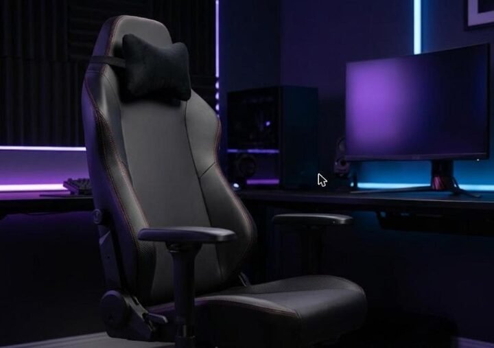 Secretlab Titan Evo review: black ergonomic gaming chair with magnetic head pillow and 4D armrests beside a purple-lit gaming desk